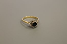 An 18ct gold diamond and sapphire cluster ring