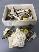 A box of military buttons, military patches, silks,