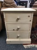 A pine three drawer bedside chest,