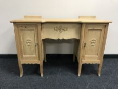 A stripped pine knee hole dressing table