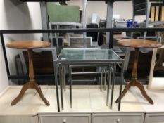 A nest of three metal and glass top tables and a pair of wine tables