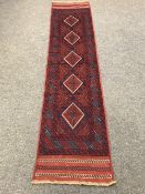 A Meshwani runner on red ground