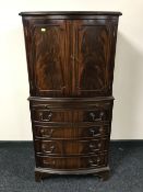 A mahogany bowfronted cocktail cabinet