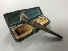 An antique bronze French whistle