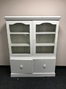 A painted oak glazed door bookcase with cupboards beneath