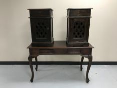 A contemporary hardwood two-drawer console table together with a pair of bedside cabinets with