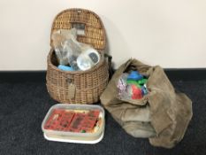 A fishing creel and tackle bag containing line, flies,