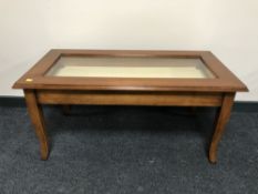 A Marks and Spencer glass topped display coffee table