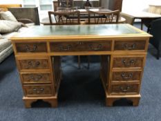 A yewwood twin pedestal desk with inset green leather panel