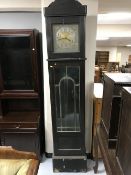 An early 20th century oak long cased with brass and silvered dial