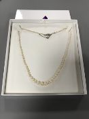 A fine quality strap of pearls with white gold clasp set with a diamond