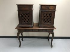 A contemporary hardwood two-drawer console table together with a pair of bedside cabinets with