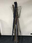 A collection of vintage fishing rods and a landing net