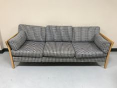 A wood framed three seater settee
