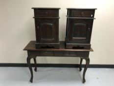A contemporary hardwood two-drawer console table together with a pair of bedside cabinets with