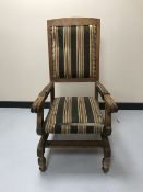 An early twentieth century mahogany framed rocking chair upholstered in a striped fabric