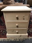 A pine three drawer bedside chest,