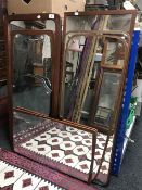 Three late 20th century teak framed mirrors and four mirrors mounted on boards (7)