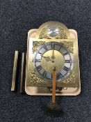 A tempus fugit brass faced clock together with pendulum and weights