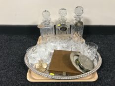 A tray containing three lead crystal decanters with labels,
