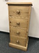 A pine narrow four drawer chest,