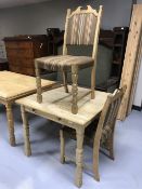 A blonde oak dining table with two chairs
