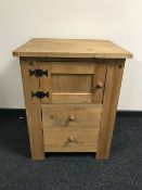 A striped pine cupboard fitted with two drawers