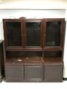A mahogany triple door display cabinet