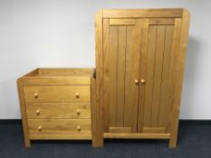 A oak child's wardrobe with baby changing unit and cot
