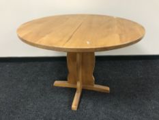 A circular pine kitchen table