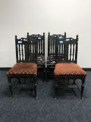 A set of four carved oak American dining chairs
