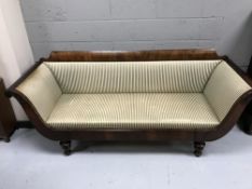 An antique mahogany scroll arm settee
