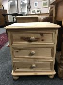 A pine three drawer bedside chest,