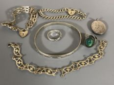 Two silver padlock bracelets, a silver locket, a bangle,