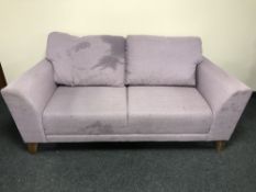 A contemporary two seater settee upholstered in mauve fabric with four scatter cushions