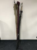 Five fishing rods in carry bags including a two piece James B Walker, three piece P.D.