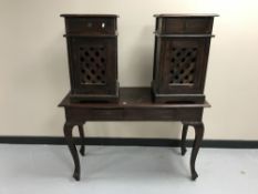 A contemporary hardwood two-drawer console table together with a pair of bedside cabinets with