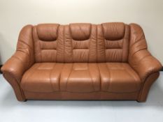 A tan leather three seater settee
