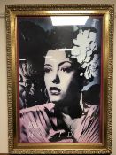 A framed Billie Holiday poster in an ornate gilt frame