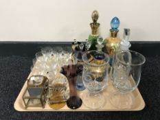 A tray containing decorative glassware including liqueur decanters, vases,