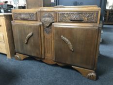 An early twentieth century carved oak double door sideboard