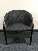 A tub chair upholstered in black fabric
