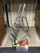 A set of folding aluminum steps, a box of hand tools,
