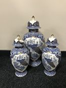 Three blue and white oriental style lidded urns with peacock decoration