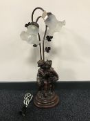 A two-way table cherub lamp with glass shades