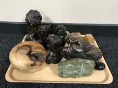 A tray of wooden carvings, carved marble paperweight depicting a Rhino,