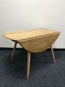 An Ercol elm drop leaf table