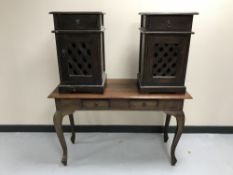A contemporary hardwood two-drawer console table together with a pair of bedside cabinets with