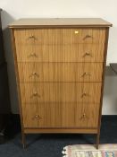 A mid 20th century teak five drawer chest