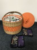 A wicker sewing basket and two Singer tins of sewing machine accessories